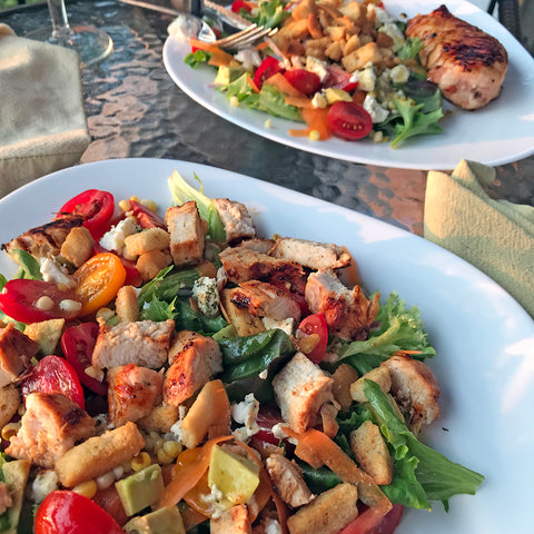 Chunks of BBQd chicken on fresh, crispy salad